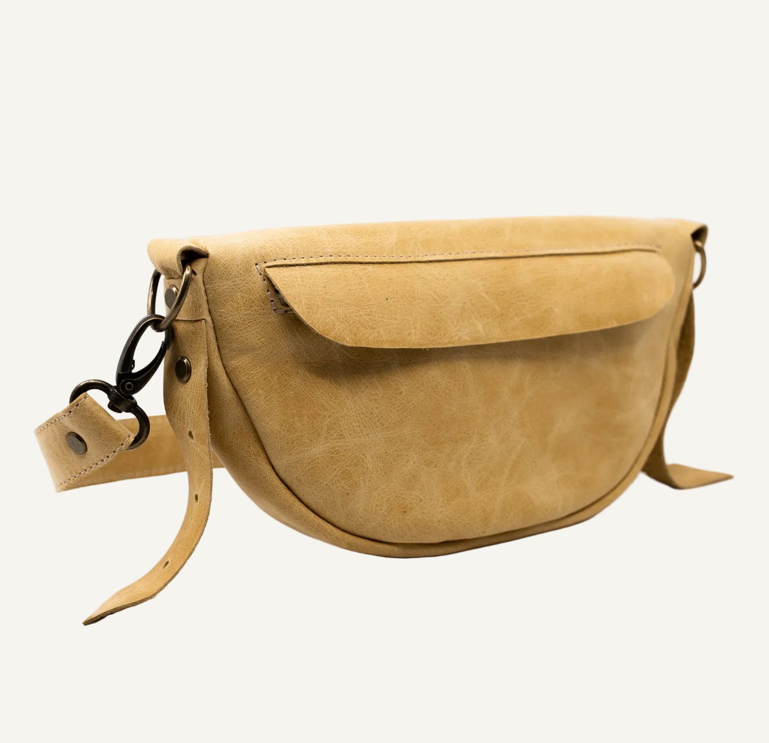 muted yellow leather bag with a strap on a white background