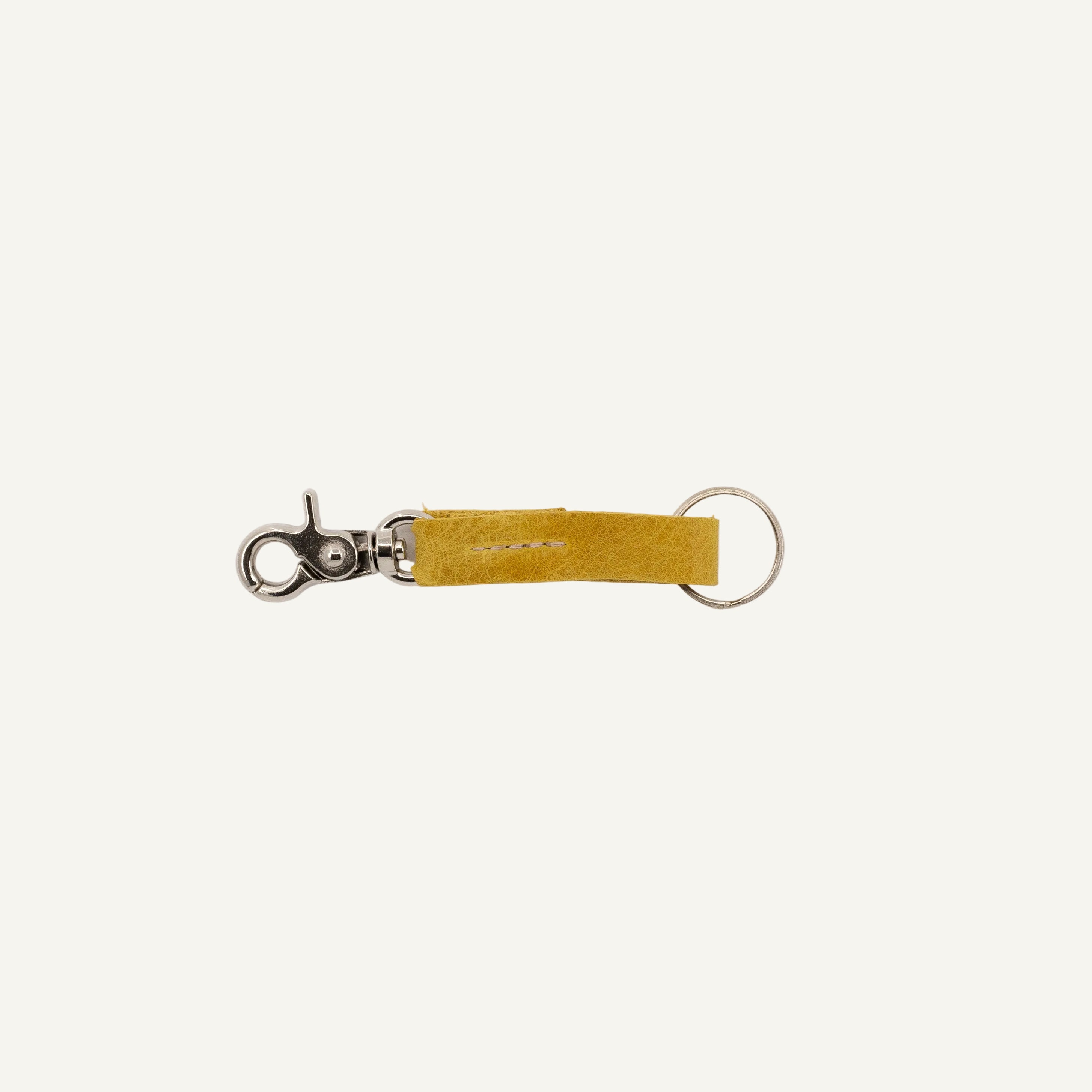 Yellow keychain with metal clip on a white background