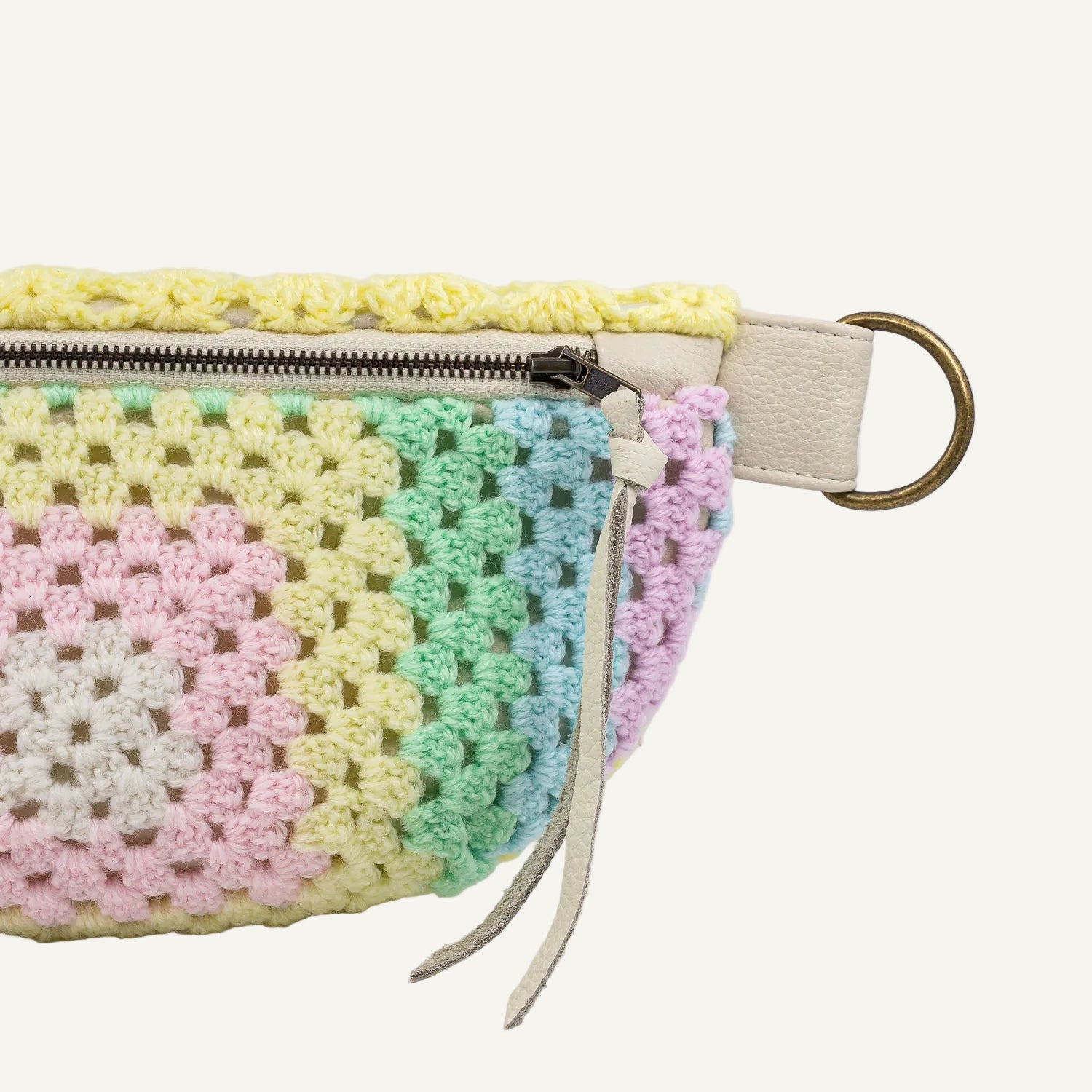 Crocheted pouch with pastel colors on a white background