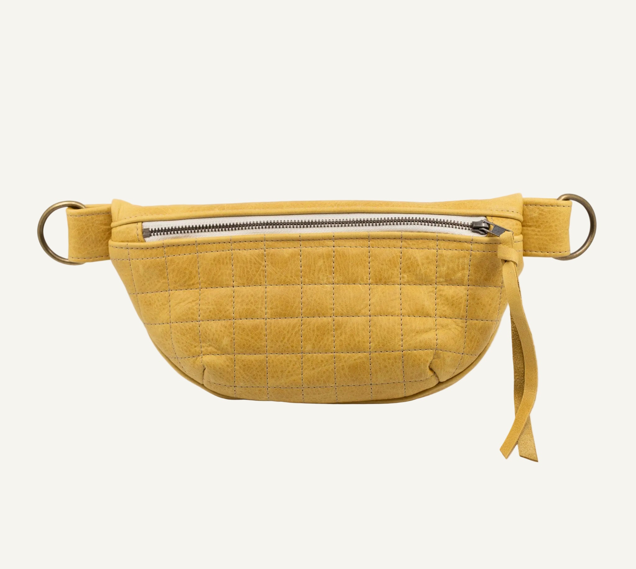 Yellow quilted fanny pack on a light gray background