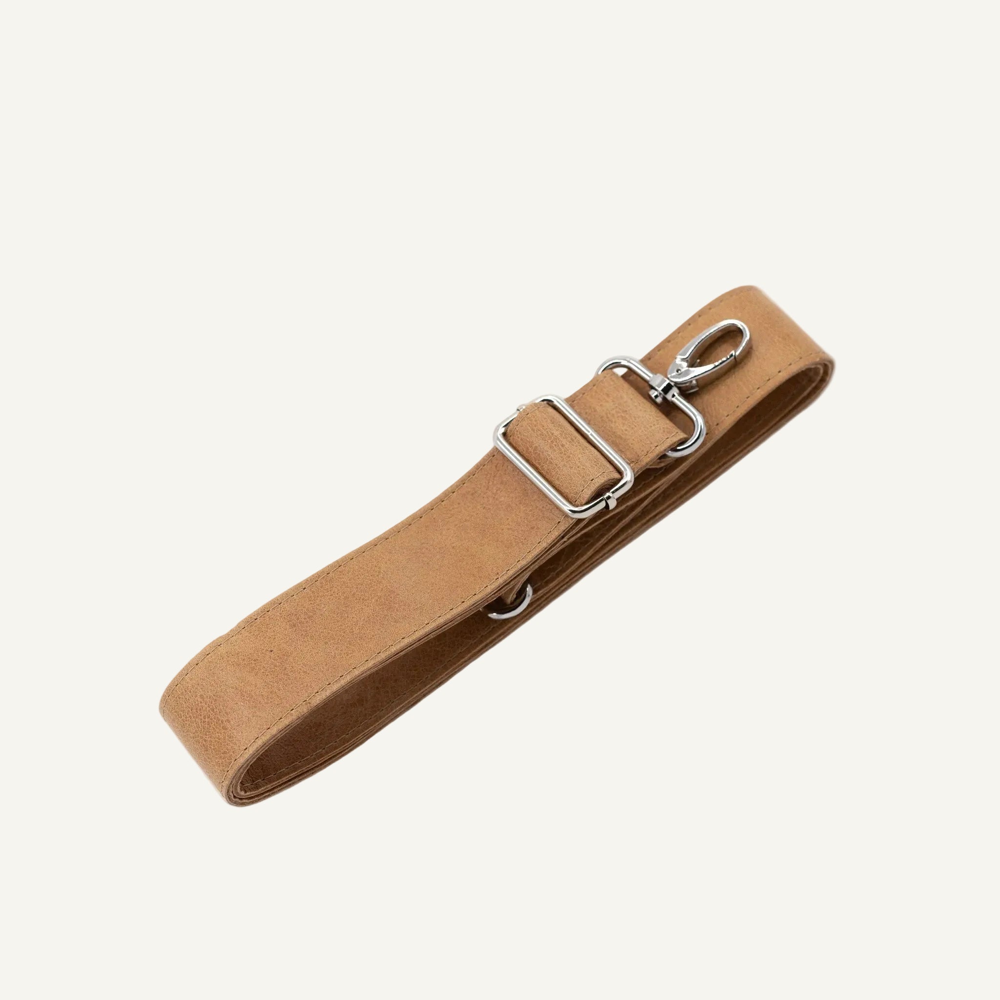 A tan leather strap with silver metal hardware, including a clip, shown on a light cream background.