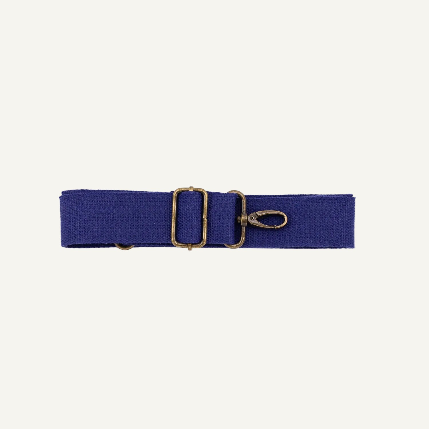 Blue cotton strap with brass clip on a white background