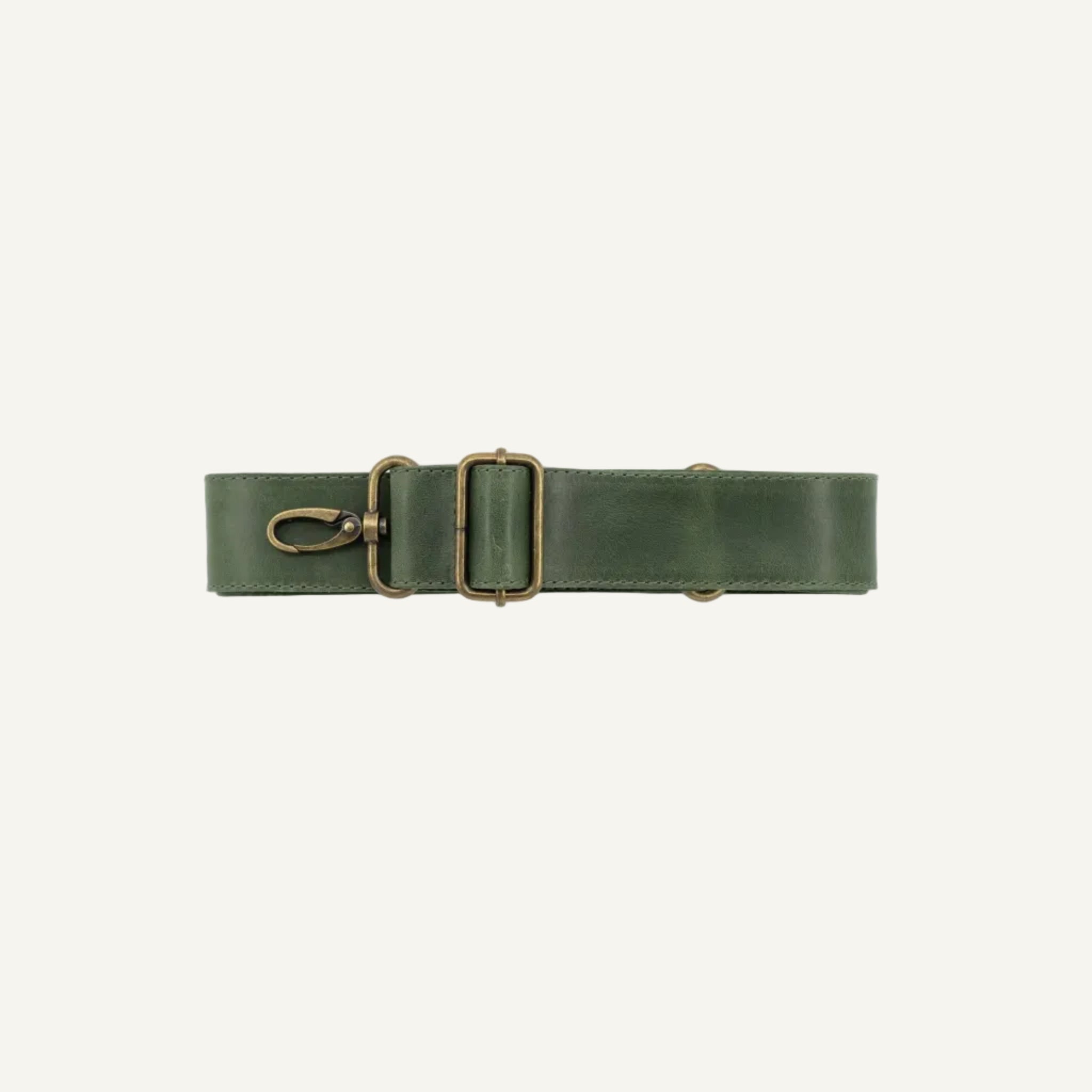 Green strap with brass clips on a white background