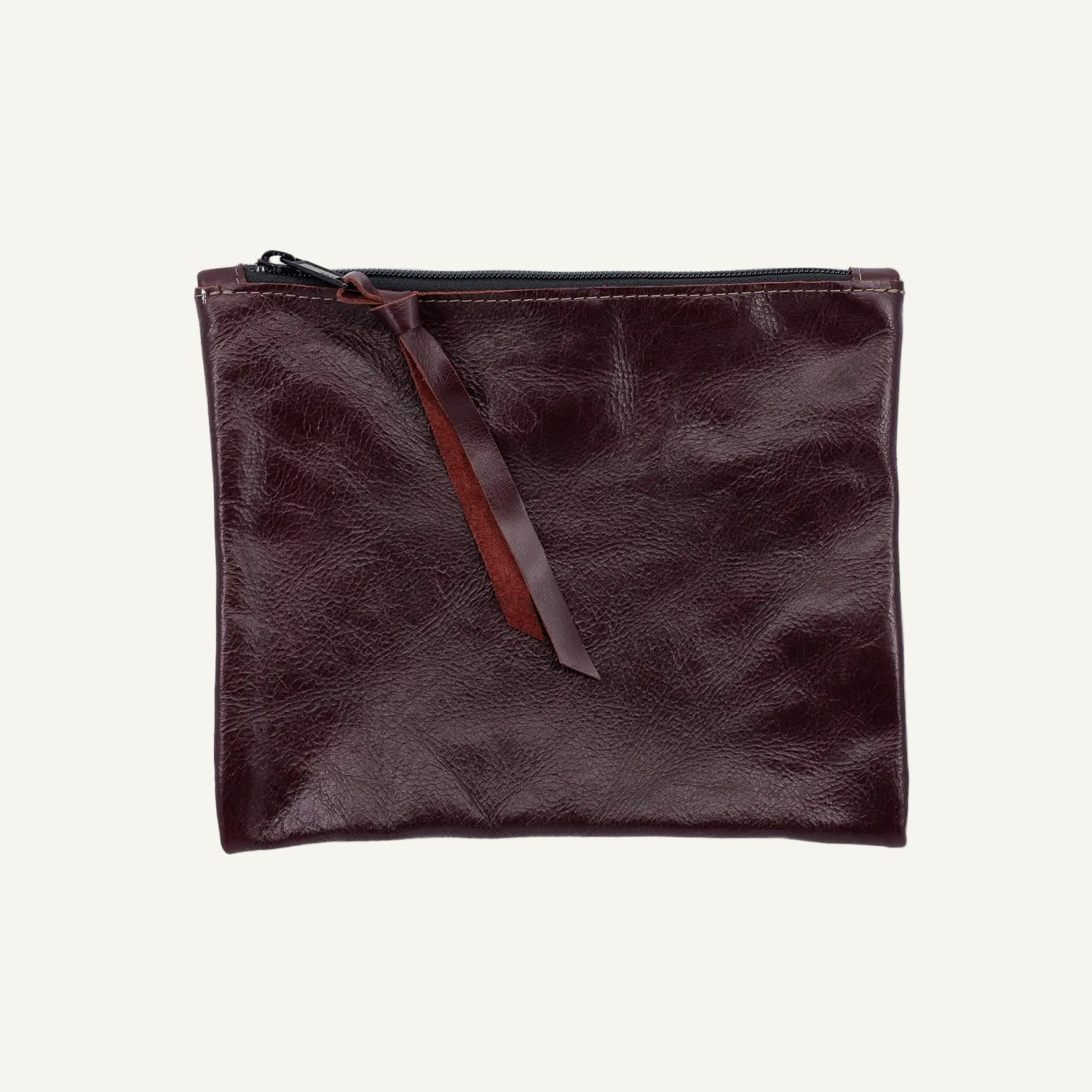 Brown leather pouch with a zipper on a white background