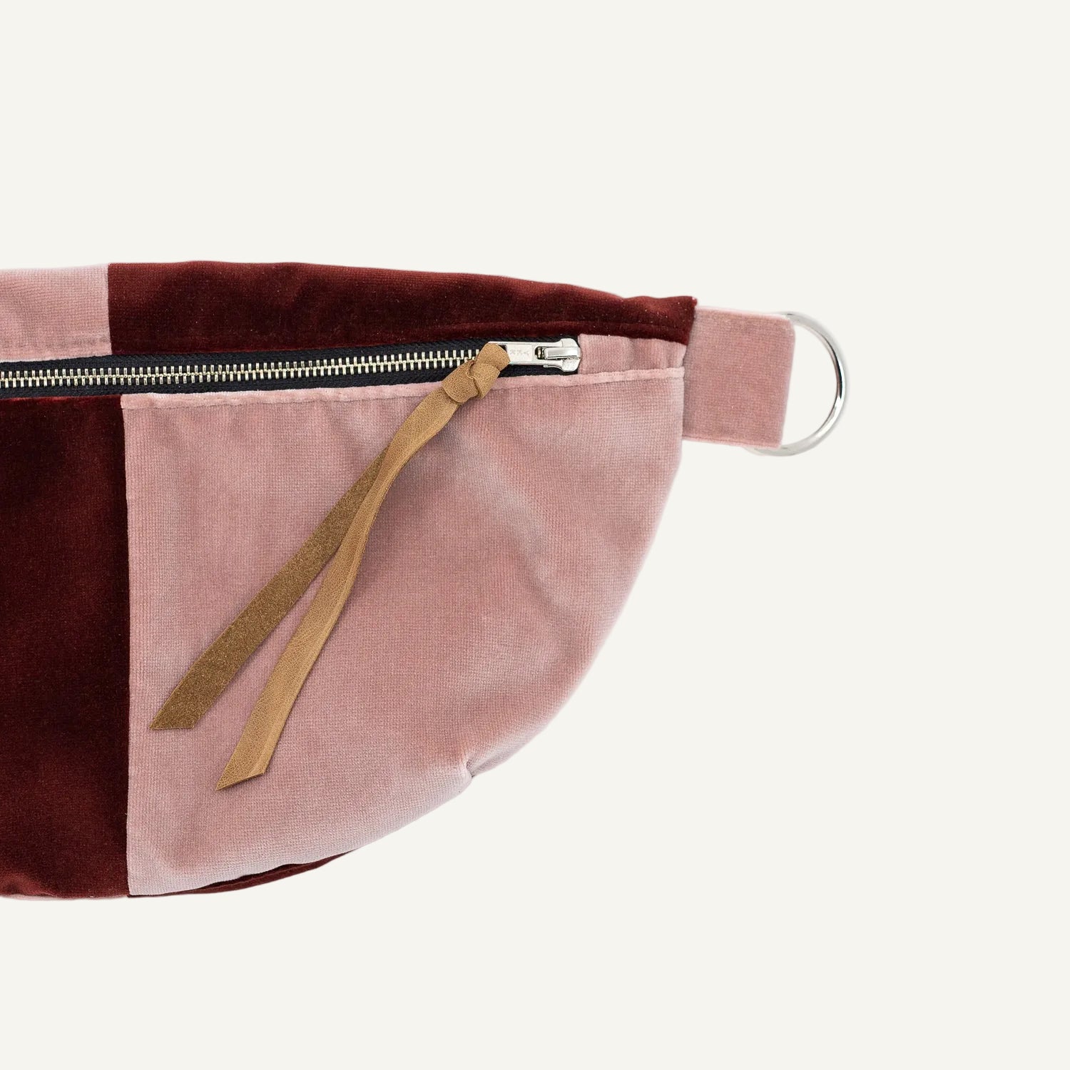 Pink and brown waist bag with a zipper on a white background