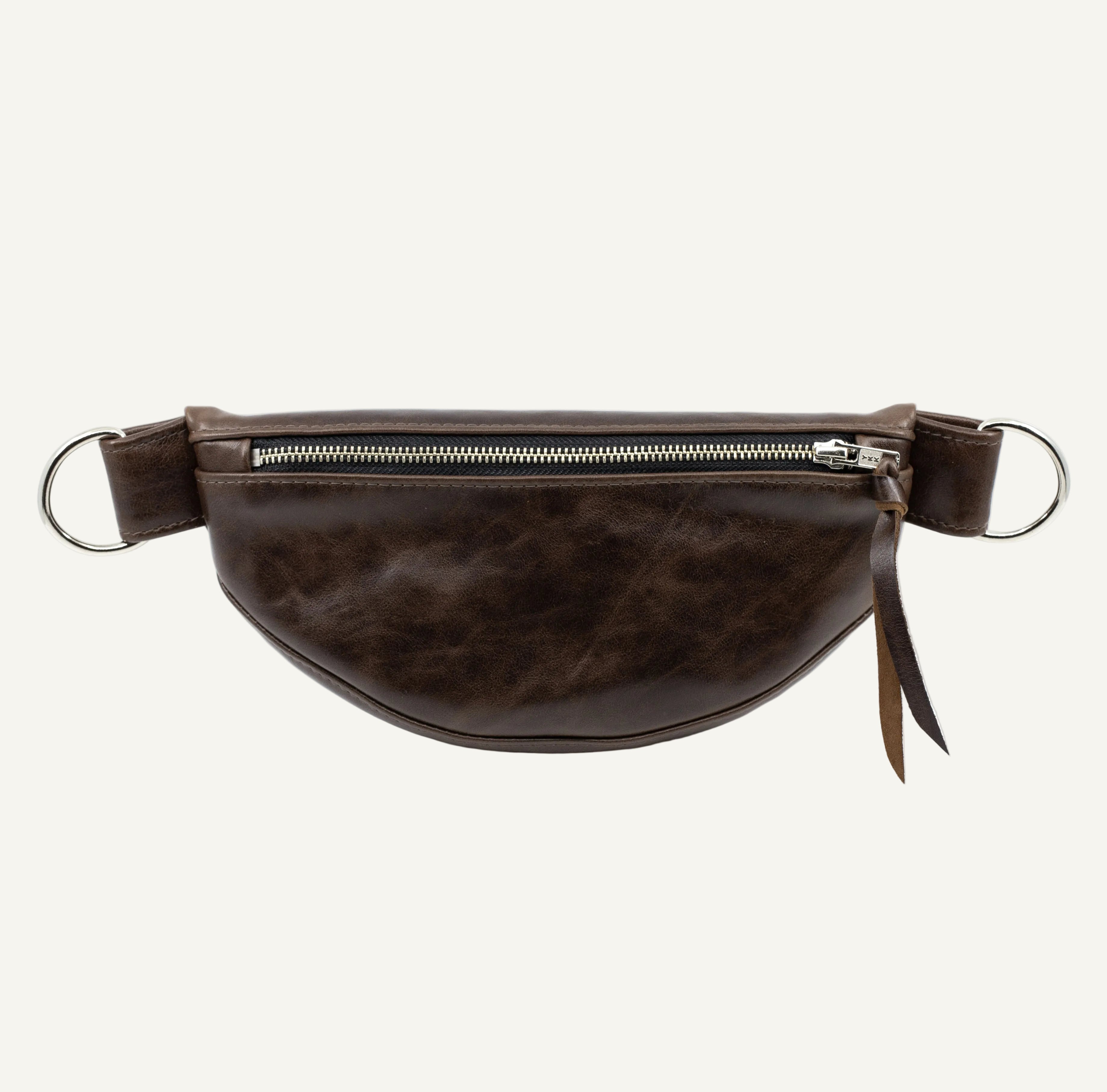 A dark brown leather fanny pack with a top zipper, silver metal D-rings shown against a plain white background.