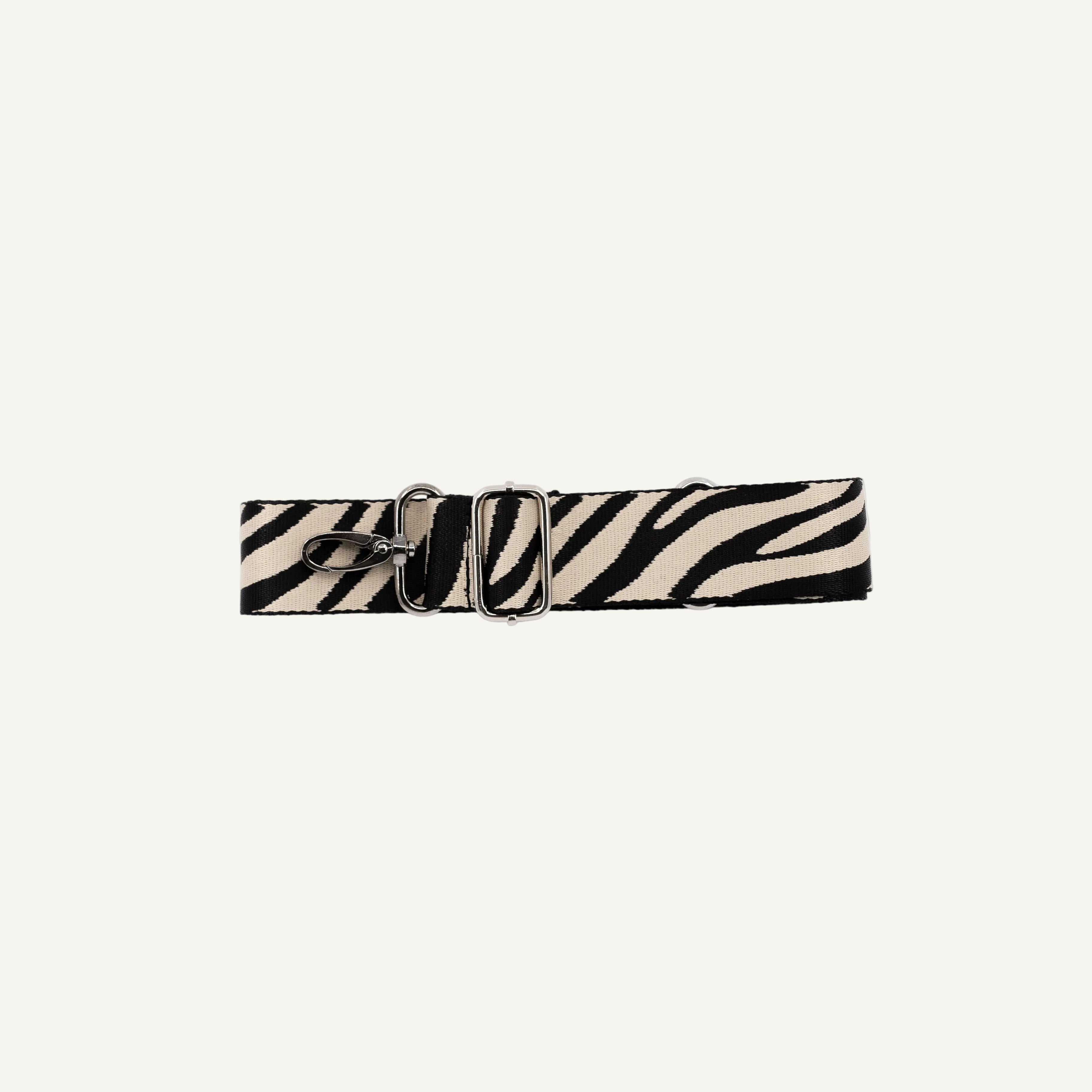 Zebra print strap with a silver clip on a white background