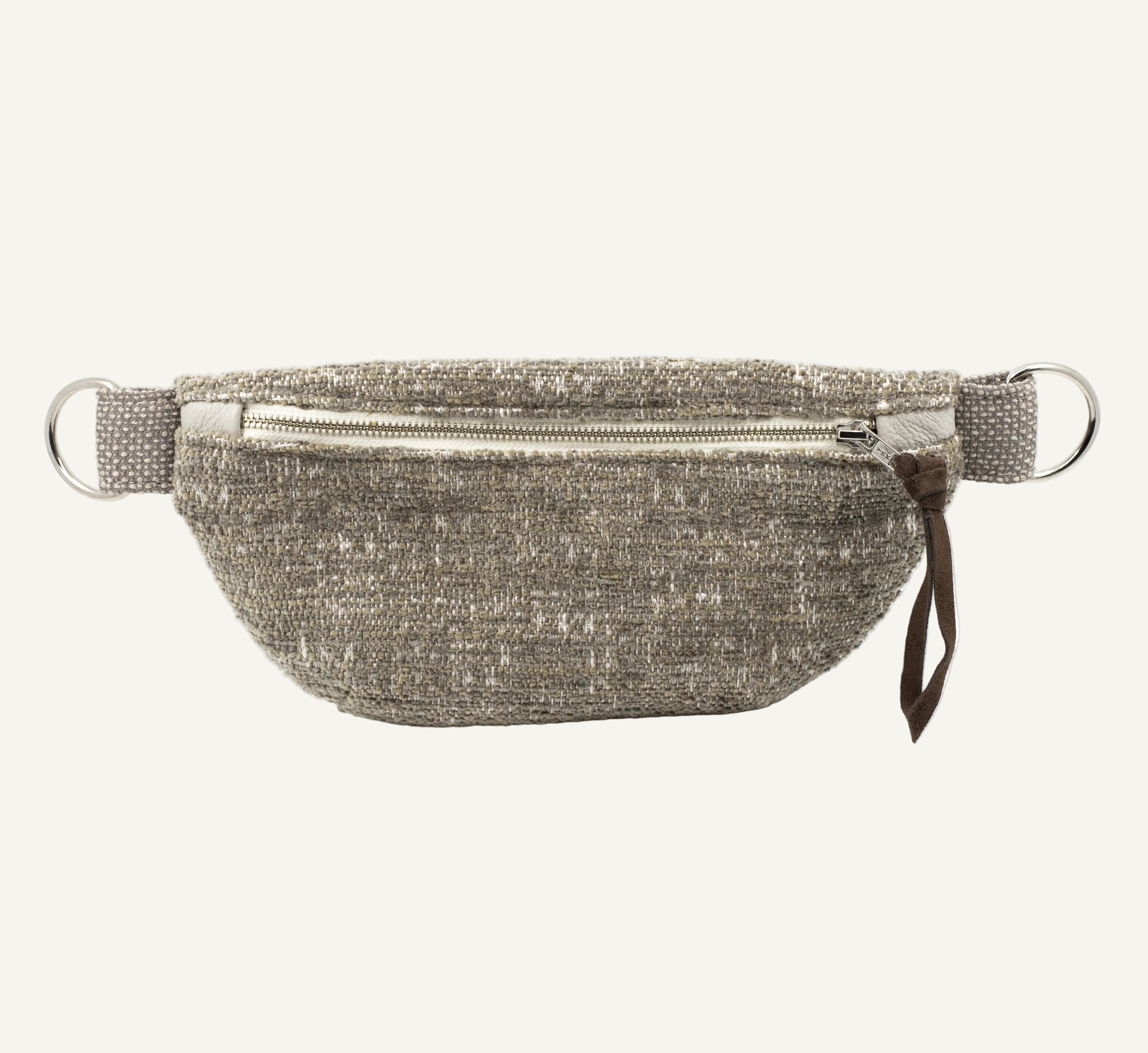 A textured woven gray and beige waist bag with a silver zipper, silver metal D-rings, and a small brown leather pull tab, shown against a plain white background.