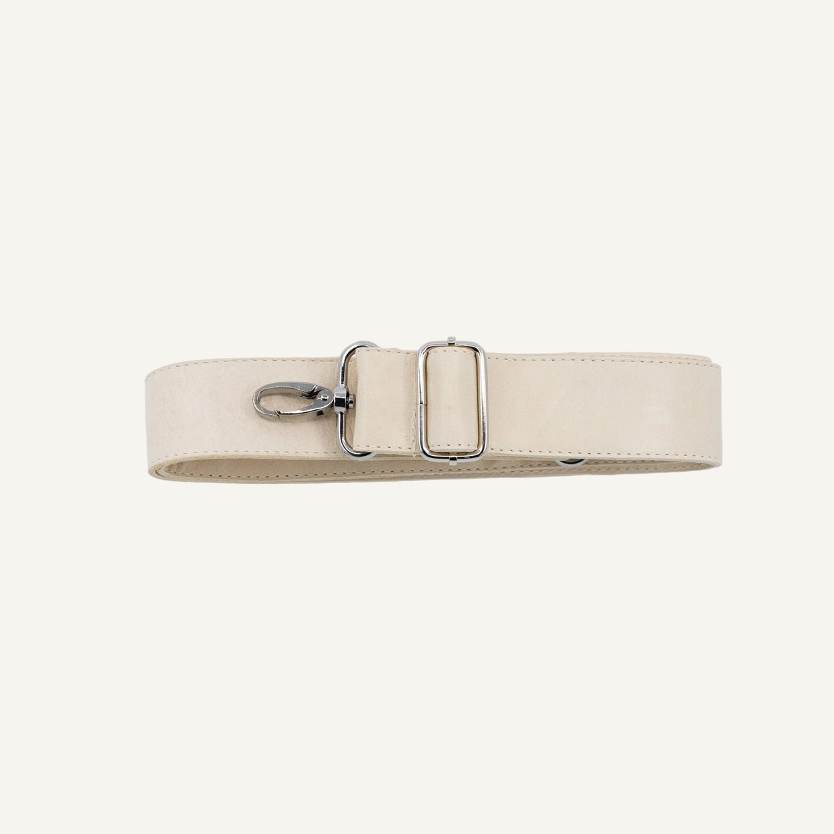 A light beige leather belt with a silver-tone metal buckle and swivel clip, laid flat on a light gray background.