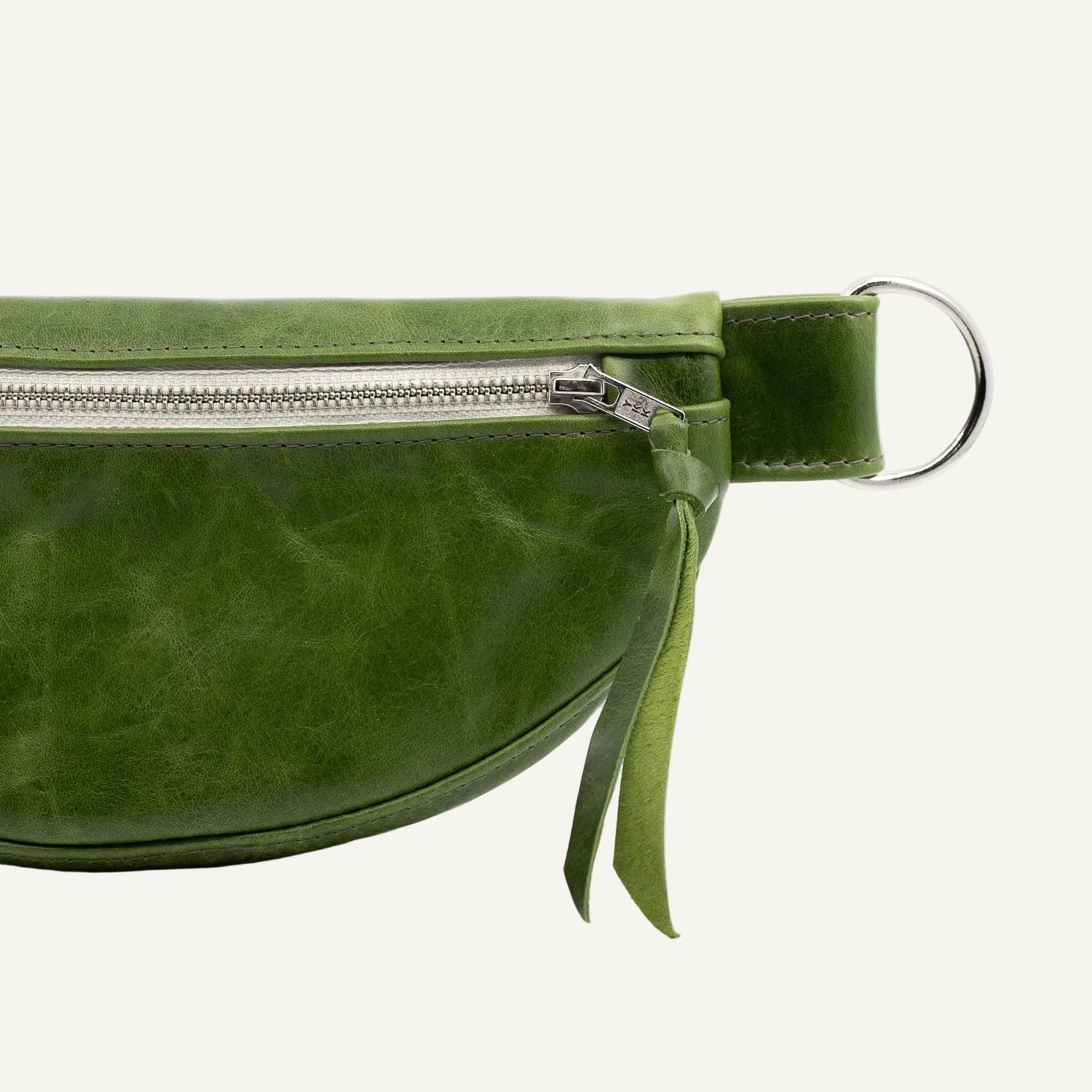 Green leather fanny pack with a zipper on a white background