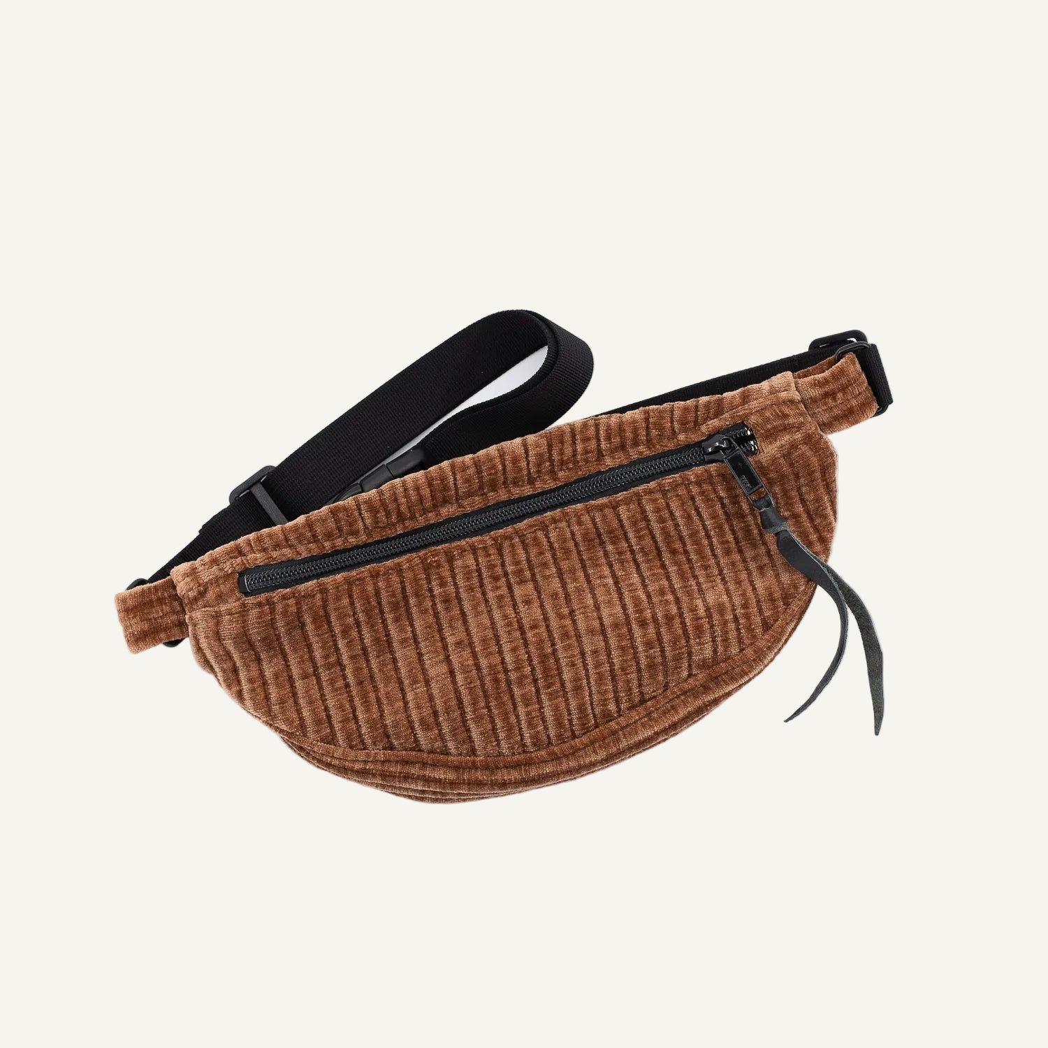Brown corduroy fanny pack with black zippers on a white background