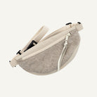 Beige waist bag with a zipper on a white background