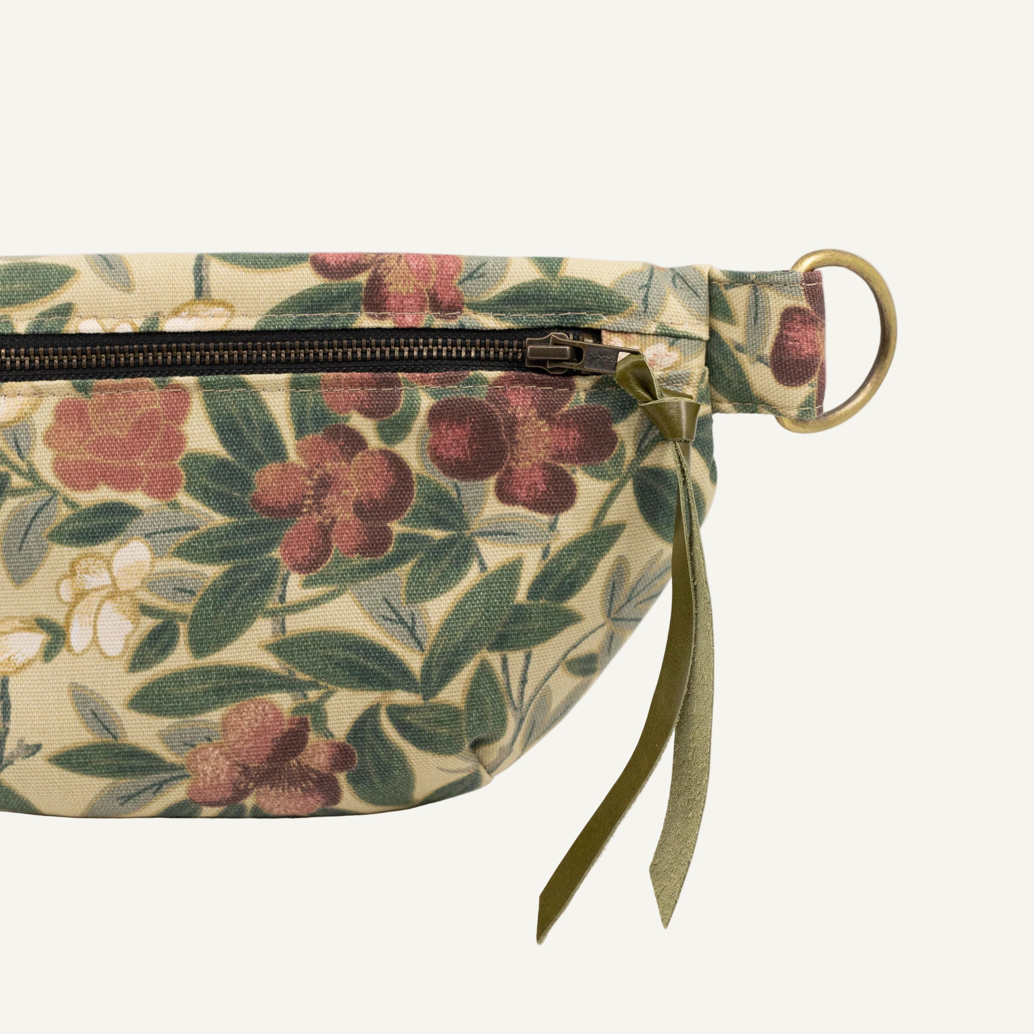 Floral-patterned bag with a strap on a white background