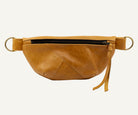 Brown leather fanny pack on a white background