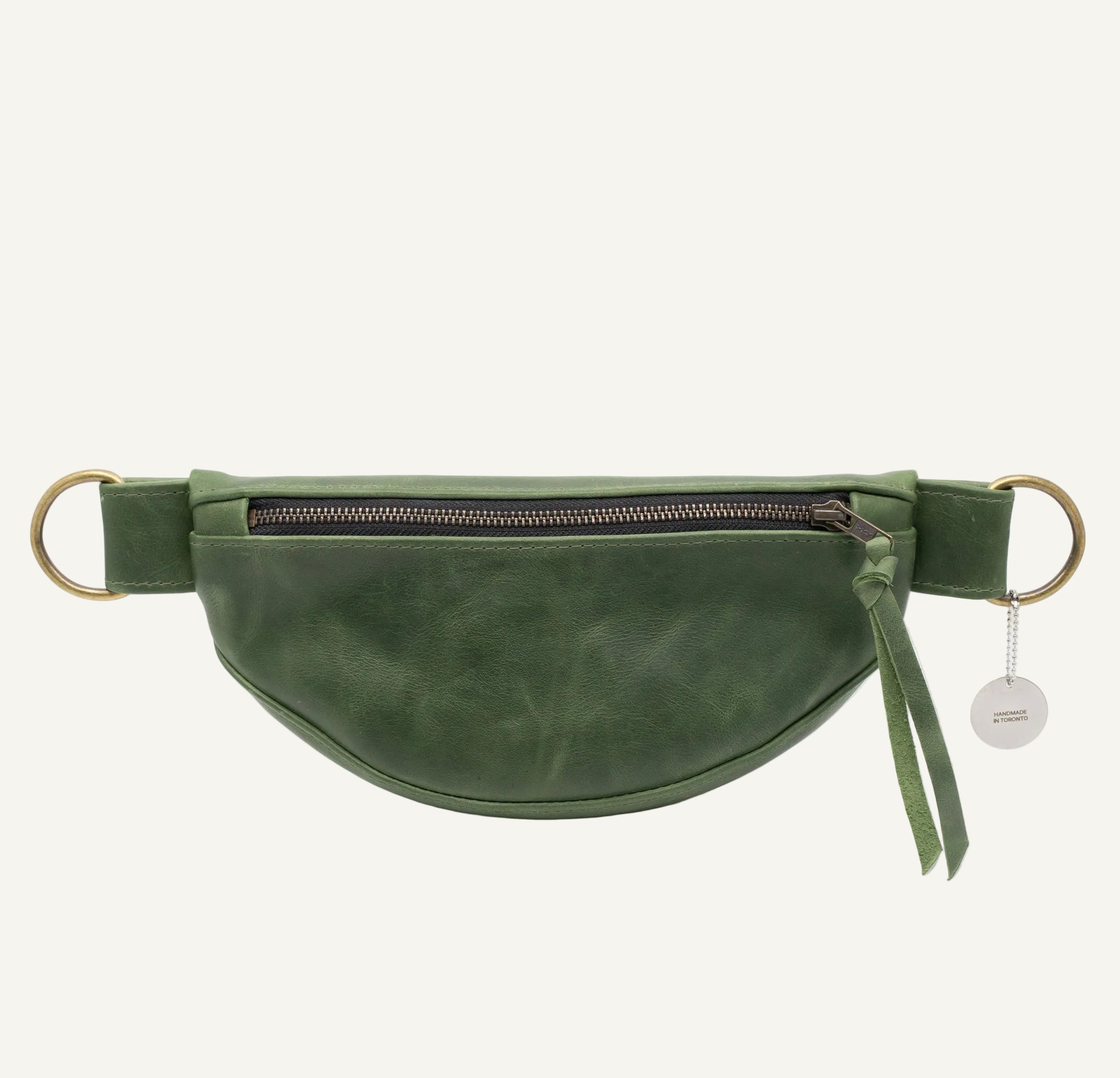 Green leather waist bag with a gold zipper on a white background