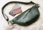 Green leather bag with phone and wallet on a white fur surface