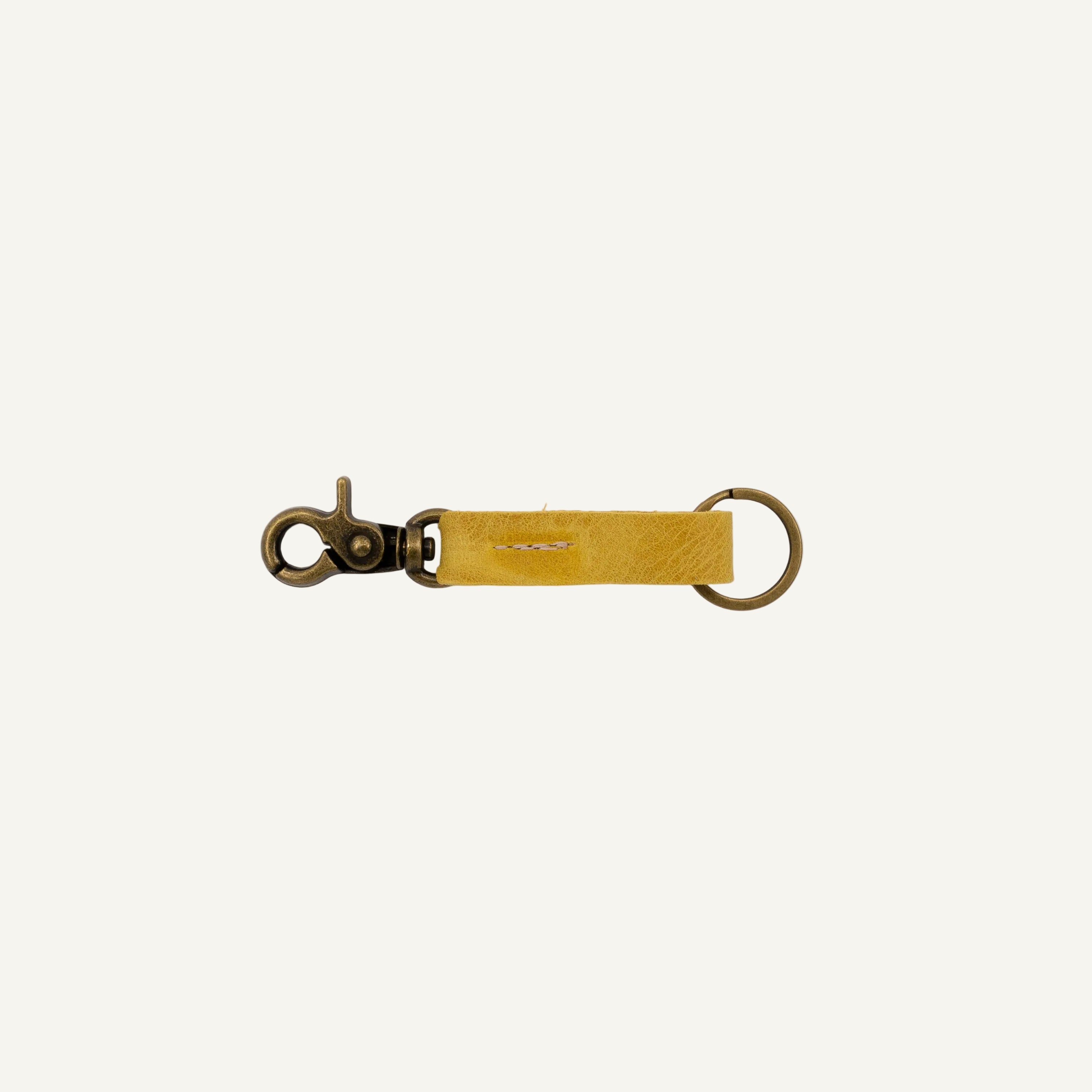 Yellow leather keychain with metal clasp on a white background