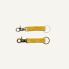 Two yellow keychains with metal clasps on a white background