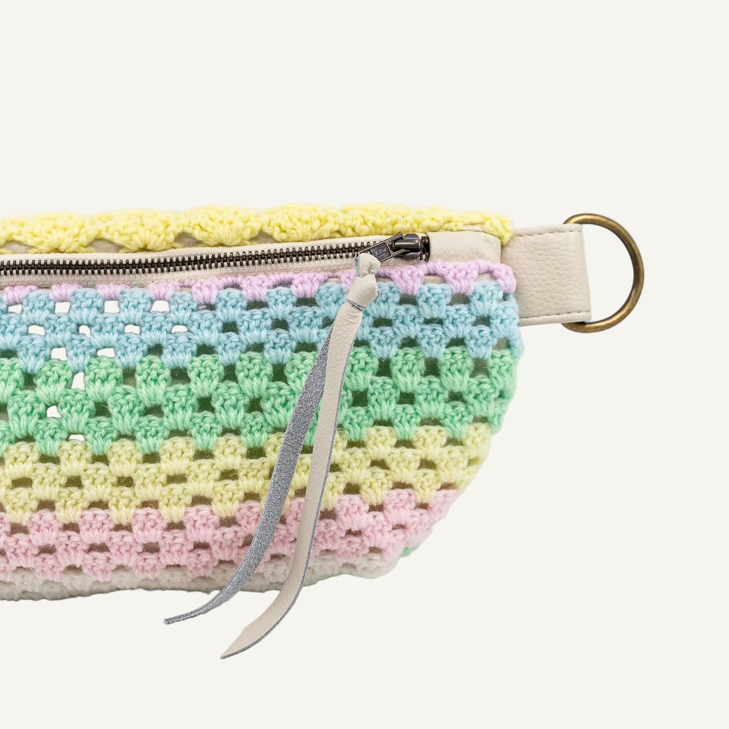 Crocheted pouch with pastel colors on a white background