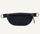 A navy blue canvas fanny pack with a brown leather zipper pull and brass hardware, shown against a plain white background.