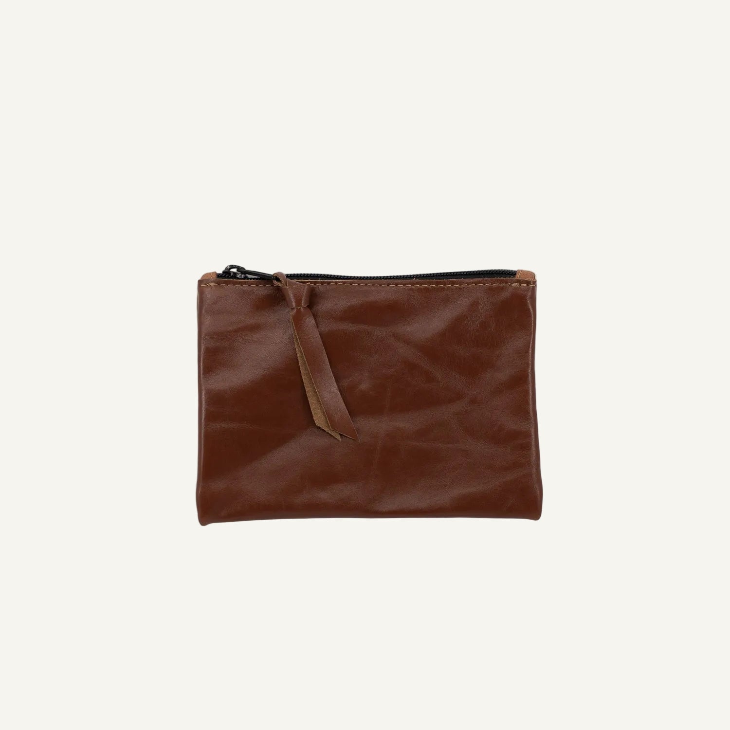 Brown leather pouch with a zipper pull on a white background