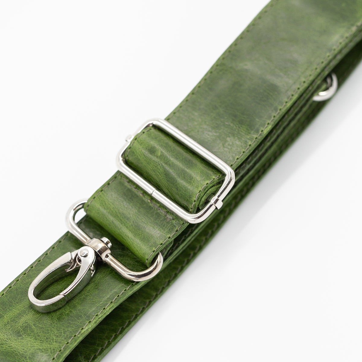 Green leather strap with silver clips on a white background