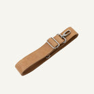 A tan leather strap with silver metal hardware, including a clip, shown on a light cream background.