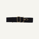Black strap with brass clips on a white background