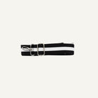 Black and white strap with metal clip on a white background