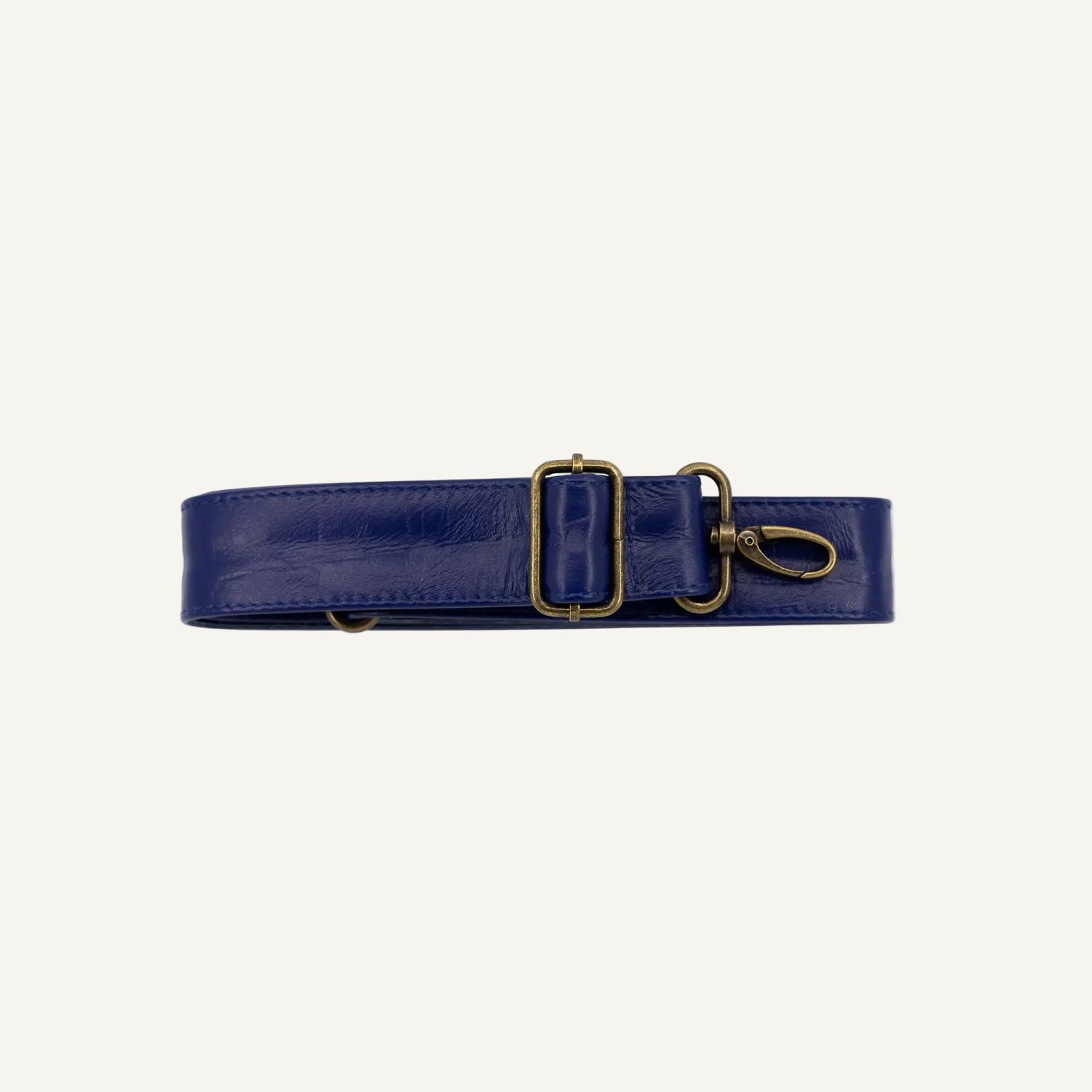 Navy strap with gold clips on a white background