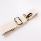 A cream cotton detachable strap with a metal clip for fanny packs.