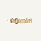 Cream strap with a herringbone pattern on a white background