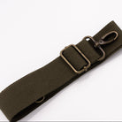 An olive green canvas strap with an antique bronze metal clasp, shown on a plain white background.