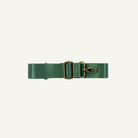 Green seatbelt strap with brass hardware on a white background