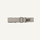 Beige belt with a silver buckle on a white background