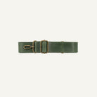 Green strap with brass clips on a white background