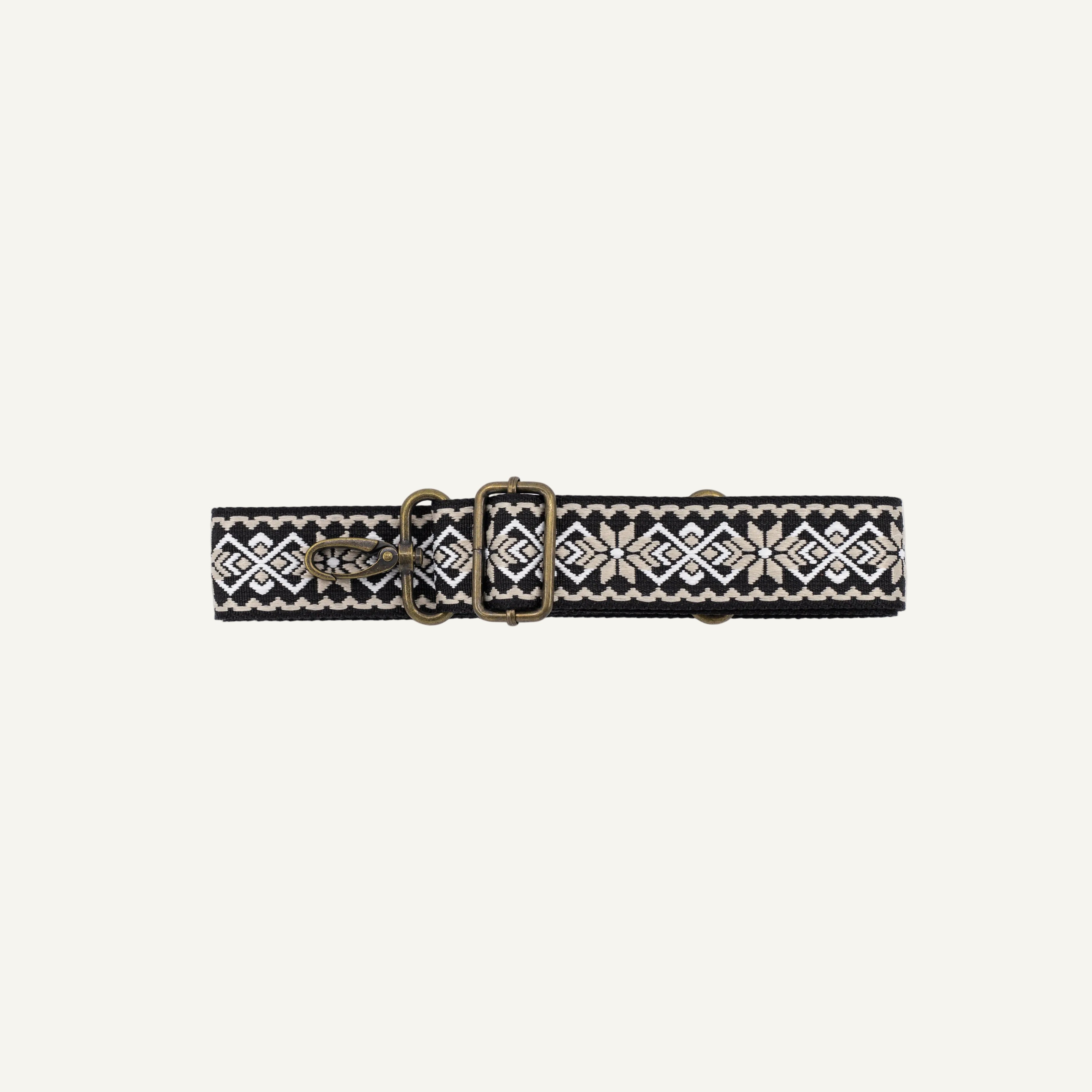 Black belt with geometric pattern and gold clip on a white background