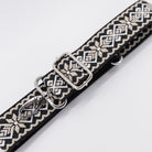 Patterned belt with metal clip on a white background