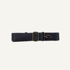 Black strap with brass clips on a white background