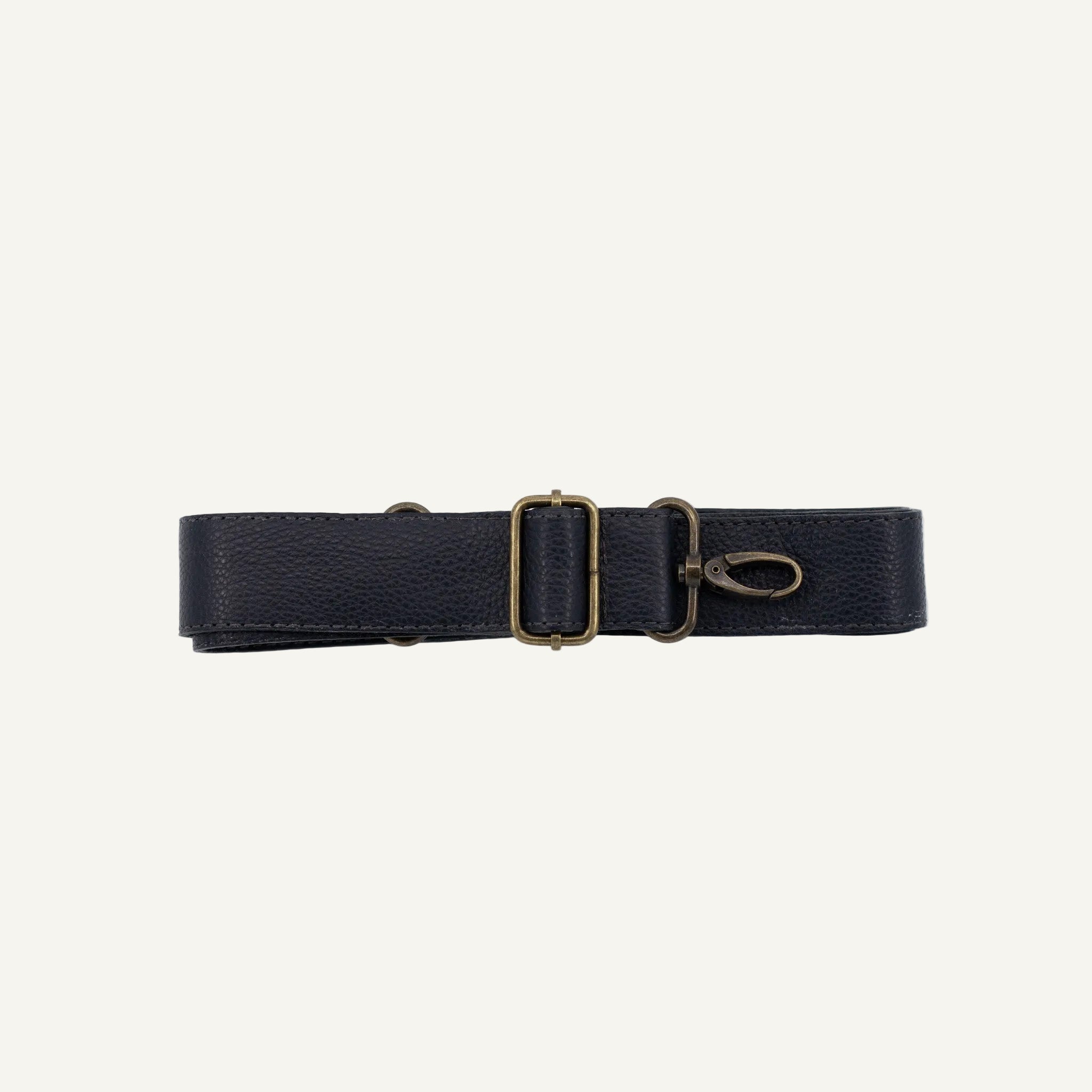 Black strap with brass clips on a white background
