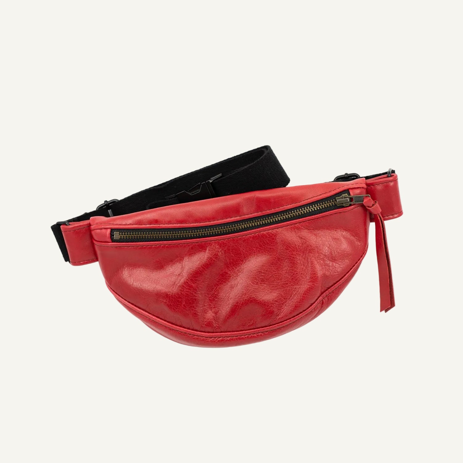 Red fanny pack with a black belt on a white background