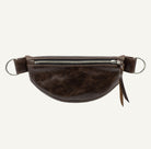 A dark brown leather fanny pack with a top zipper, silver metal D-rings shown against a plain white background.