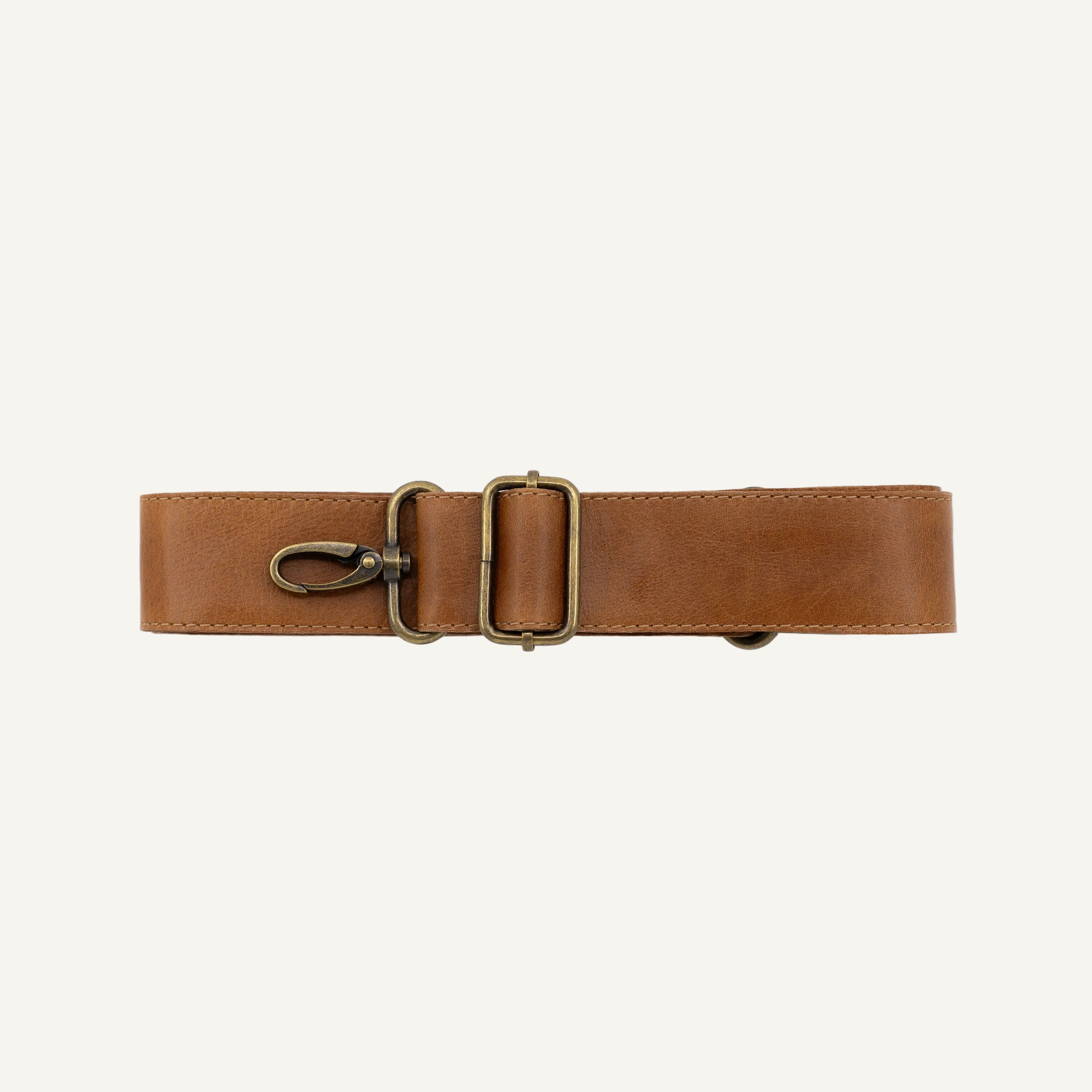 Brown leather belt with brass buckle on a white background