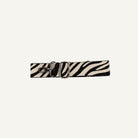 Zebra print strap with a silver clip on a white background