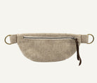 A beige linen waist bag with a front zipper, brass-tone metal rings, and a brown leather pull tab, shown against a plain white background.