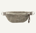 A textured woven gray and beige waist bag with a silver zipper, silver metal D-rings, and a small brown leather pull tab, shown against a plain white background.