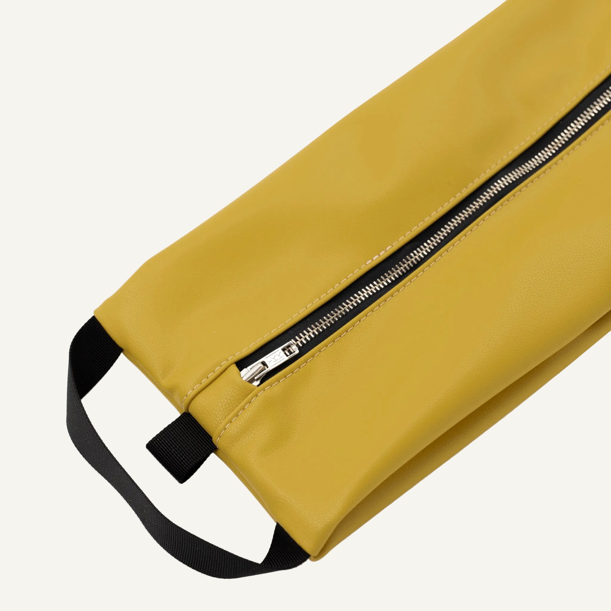 Yellow storage bag with a black strap and zipper on a white background
