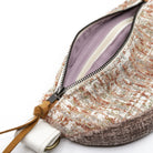 Close-up of a textured tweed pouch bag with a silver zipper, tan leather pull tab, and a light purple interior lining on a white background.