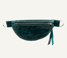 A dark teal green leather fanny pack with a front zipper pocket, silver metal rings, and a matching zipper tassel, shown against a plain white background.