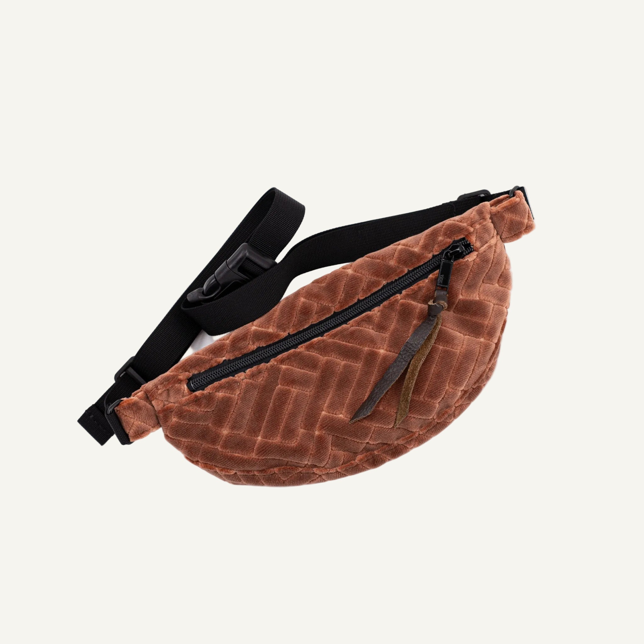 Brown textured fanny pack with a black strap on a white background